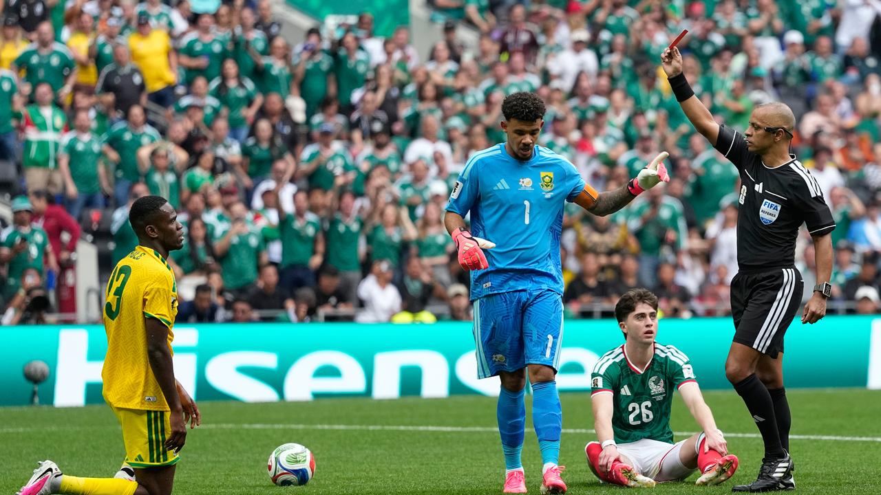 Referee Wilton Sampaio brandishes a red card to South Africa's Sphephelo Sithole