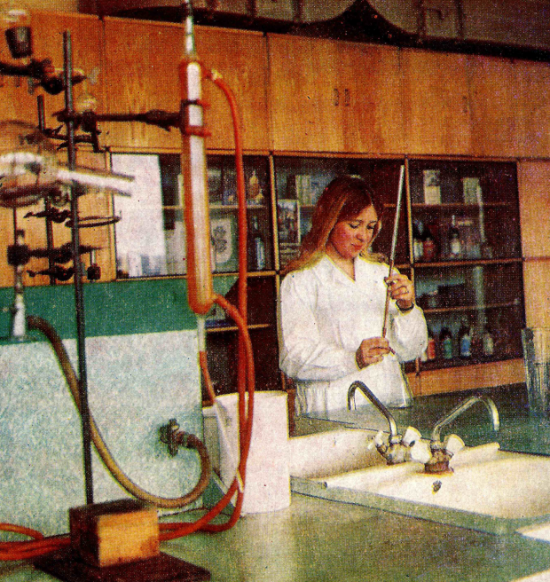 Archival photo from 1977 of a woman wearing a white coat and working in a laboratory.