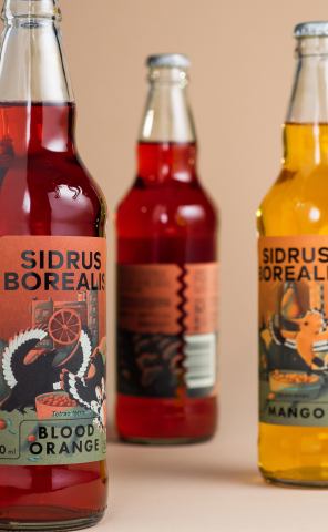 An image of three glass bottles of Sidrus Borealis cyders