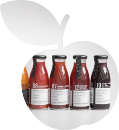 Shape of an apple that contains an image of juices and nectars glass bottles arranged in a line