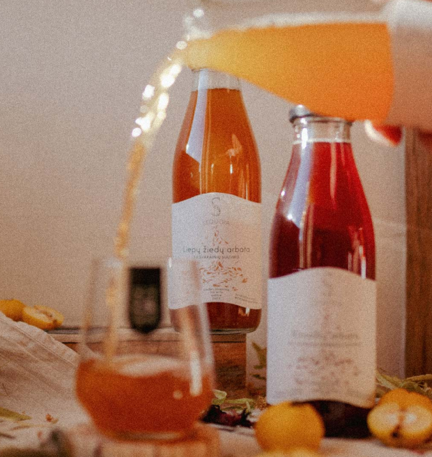 Bottle of juices and nectars being poured to a glass