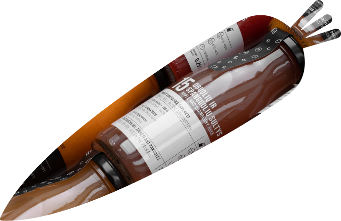 An image in a shape of carrot through which glass bottles of juices and nectars are visible