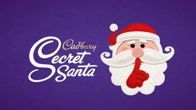 Cadbury Secret Santa, felt Santa with finger to mouth shushing