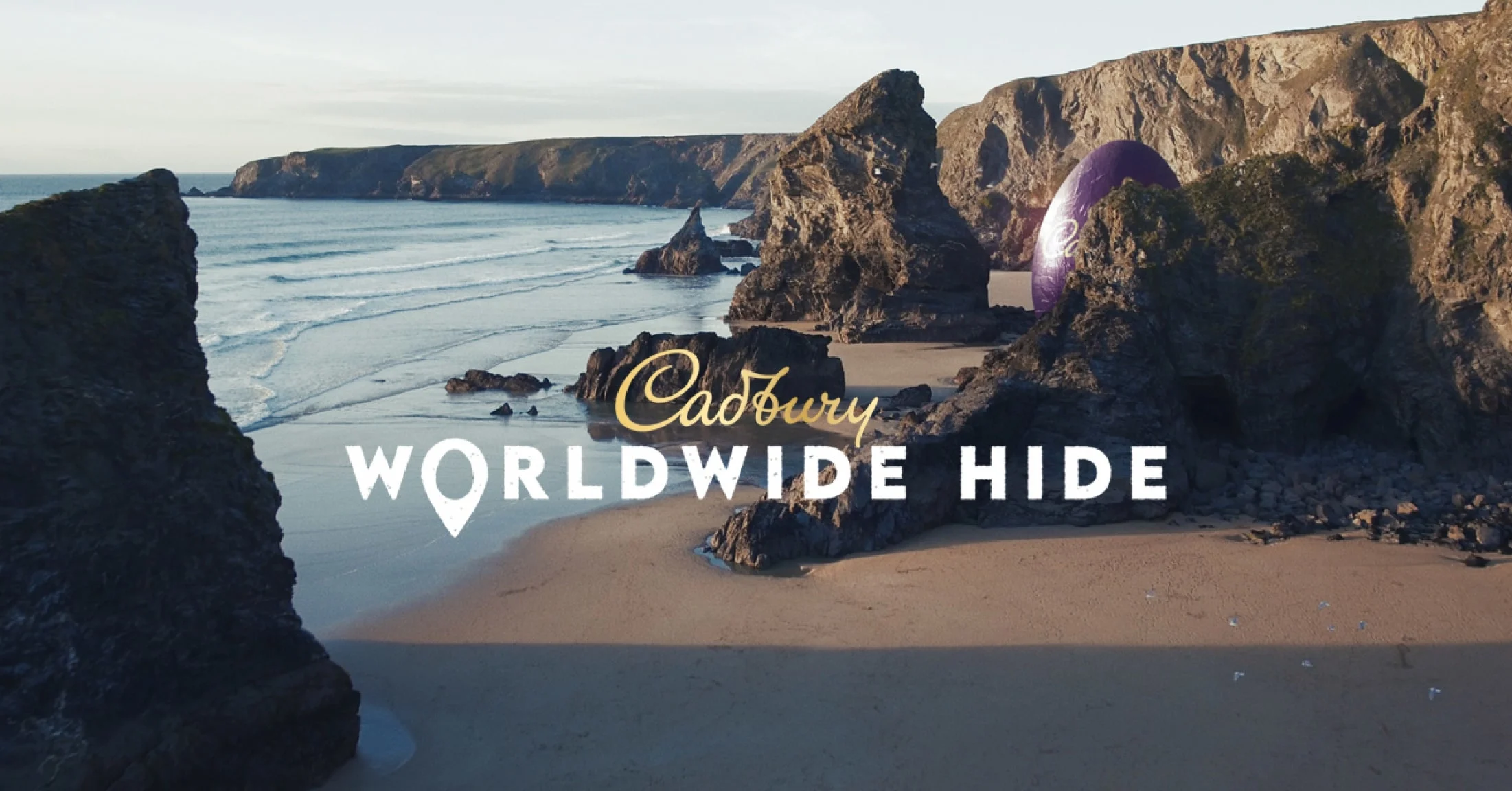 Cadbury Worldwide Hide, with giant easter egg hidden behind cliffs on a beach