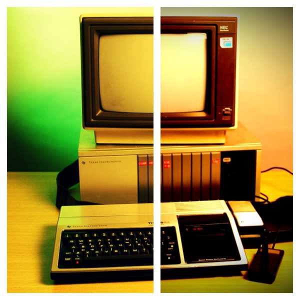 an artistically lit photo of the TI 99/4a computer system, with a screen, disk drive and joystick