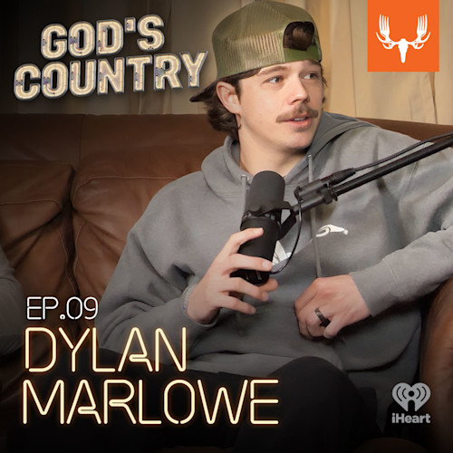 GOD'S COUNTRY; EP.09 DYLAN MARLOWE — man in cap holding podcast microphone on couch