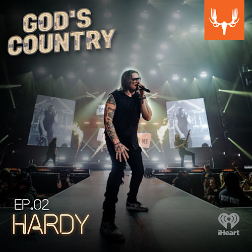 Male singer on stage with "GOD'S COUNTRY" title, "EP.02" text and MeatEater logo
