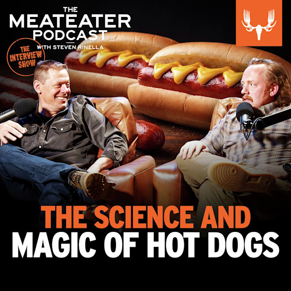THE SCIENCE AND MAGIC OF HOT DOGS — two men with microphones, oversized hot dogs background