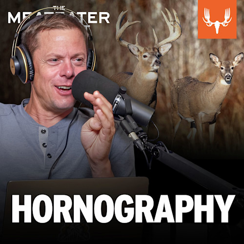 'HORNOGRAPHY' overlay; man speaking into microphone with two deer behind him