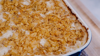 Baked turkey tetrazzini in ceramic casserole dish topped with crispy cornflake crumbs