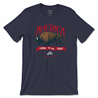 Navy tee with red "AMERICA" above a bison, ribbon "LAND OF THE FREE", "SINCE 1776", "MEATEATER"