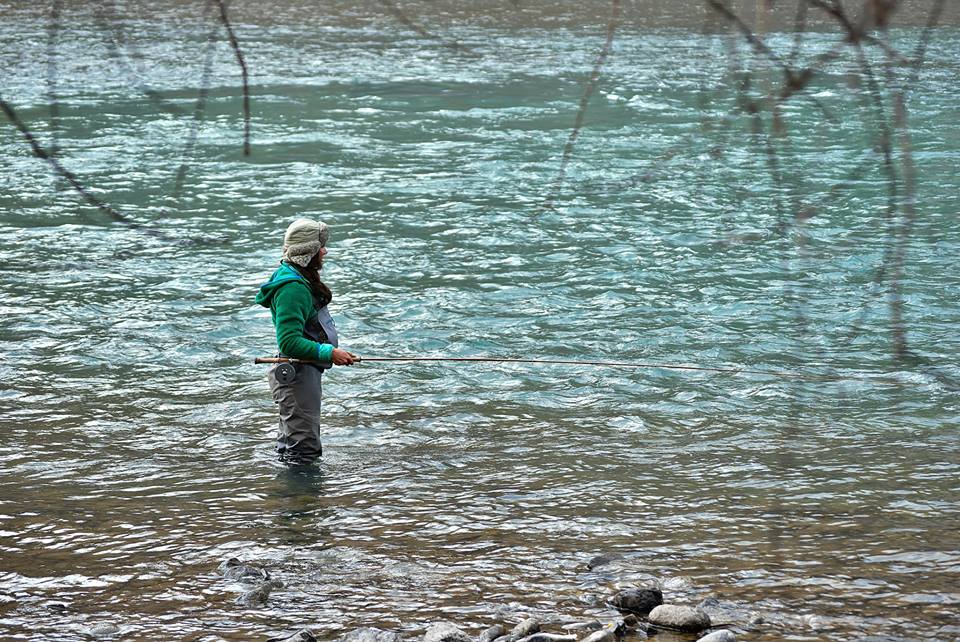 Spey fly rod and reel resting on wet rocks beside a river. Jigsaw Puzzle