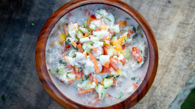Poisson cru — raw fish ceviche with diced cucumber, tomato, and carrot in milky citrus