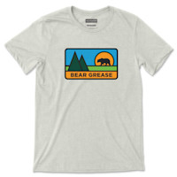 Light gray tee with mountain-and-bear graphic and text 'BEAR GREASE'; 'MEATEATER' label