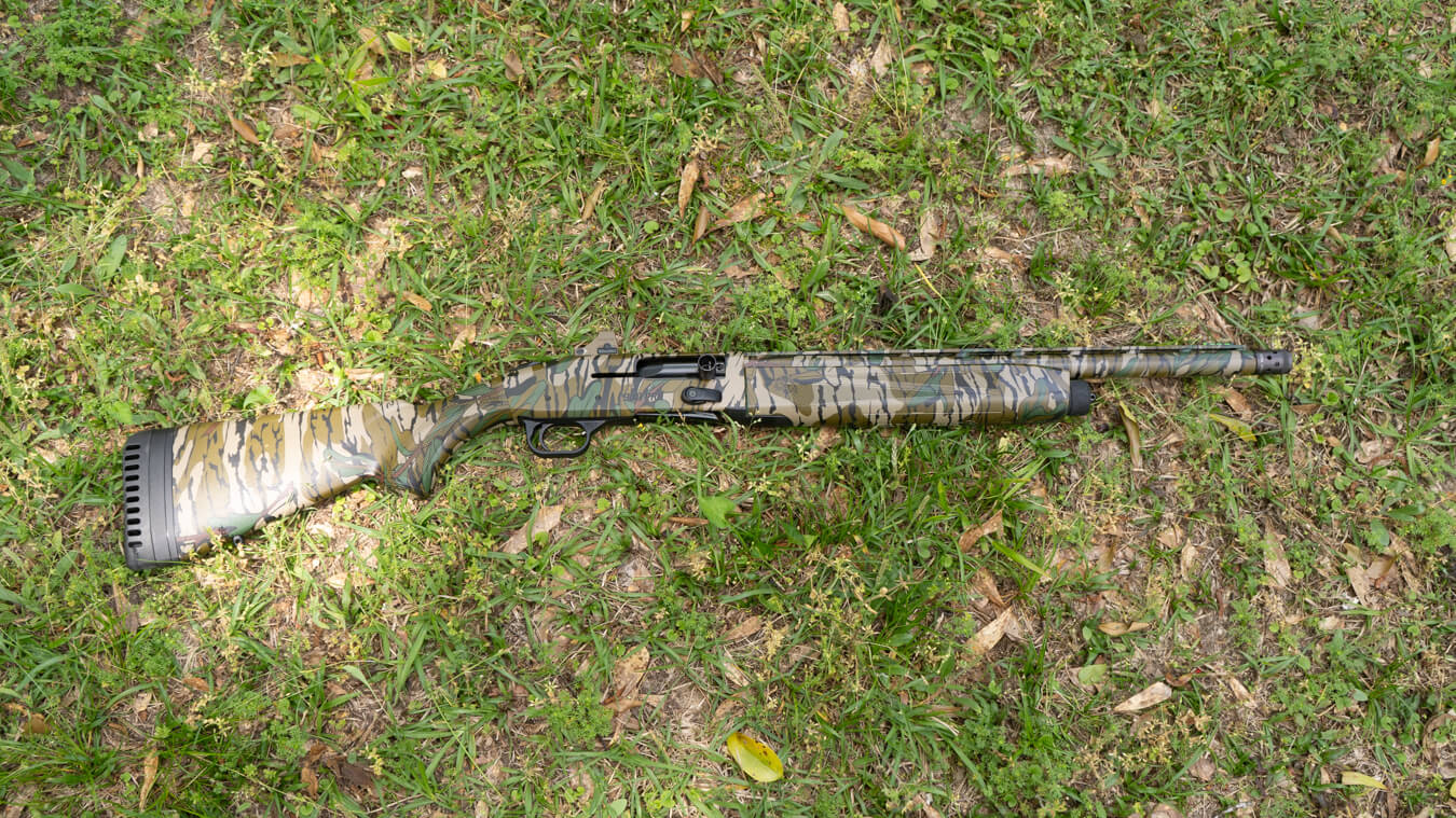 Camouflage hunting shotgun with synthetic stock and recoil pad