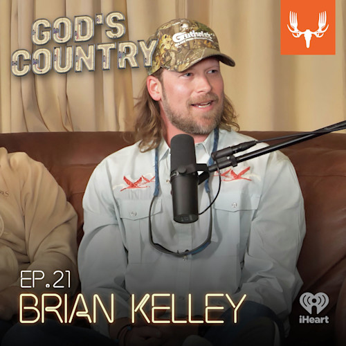 Bearded man in camo cap speaking into microphone; text: GOD'S COUNTRY, EP.21 BRIAN KELLEY