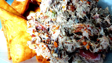 Creamy shredded fish and bacon salad with crispy fried wonton triangles, red pepper flakes
