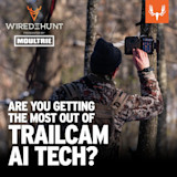 Hunter adjusts a trail camera on a tree; overlay text "WIRED TO HUNT presented by MOULTRIE"