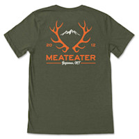 Green T-shirt with orange elk antlers and mountain, text MEATEATER and Bozeman, MT