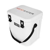 White YETI Roadie 24 cooler with "MEATEATER" printed on lid and YETI logo on front