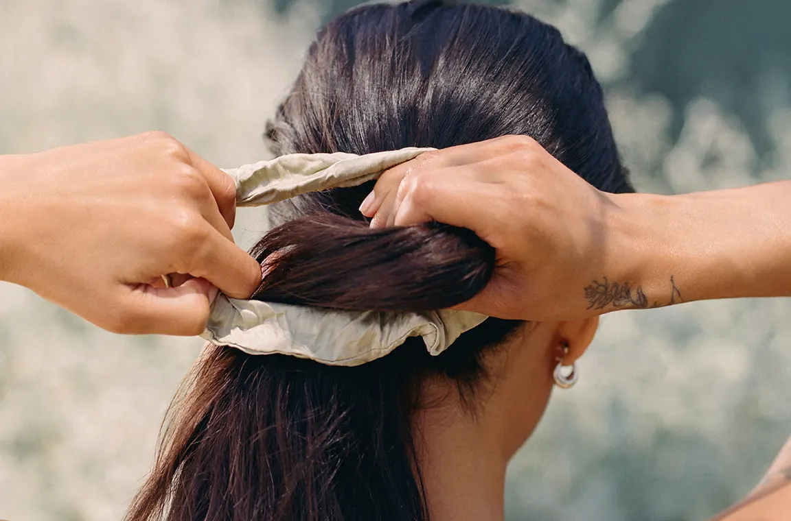 Woman tying her hair up