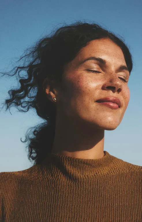 A woman with sunlight on her face