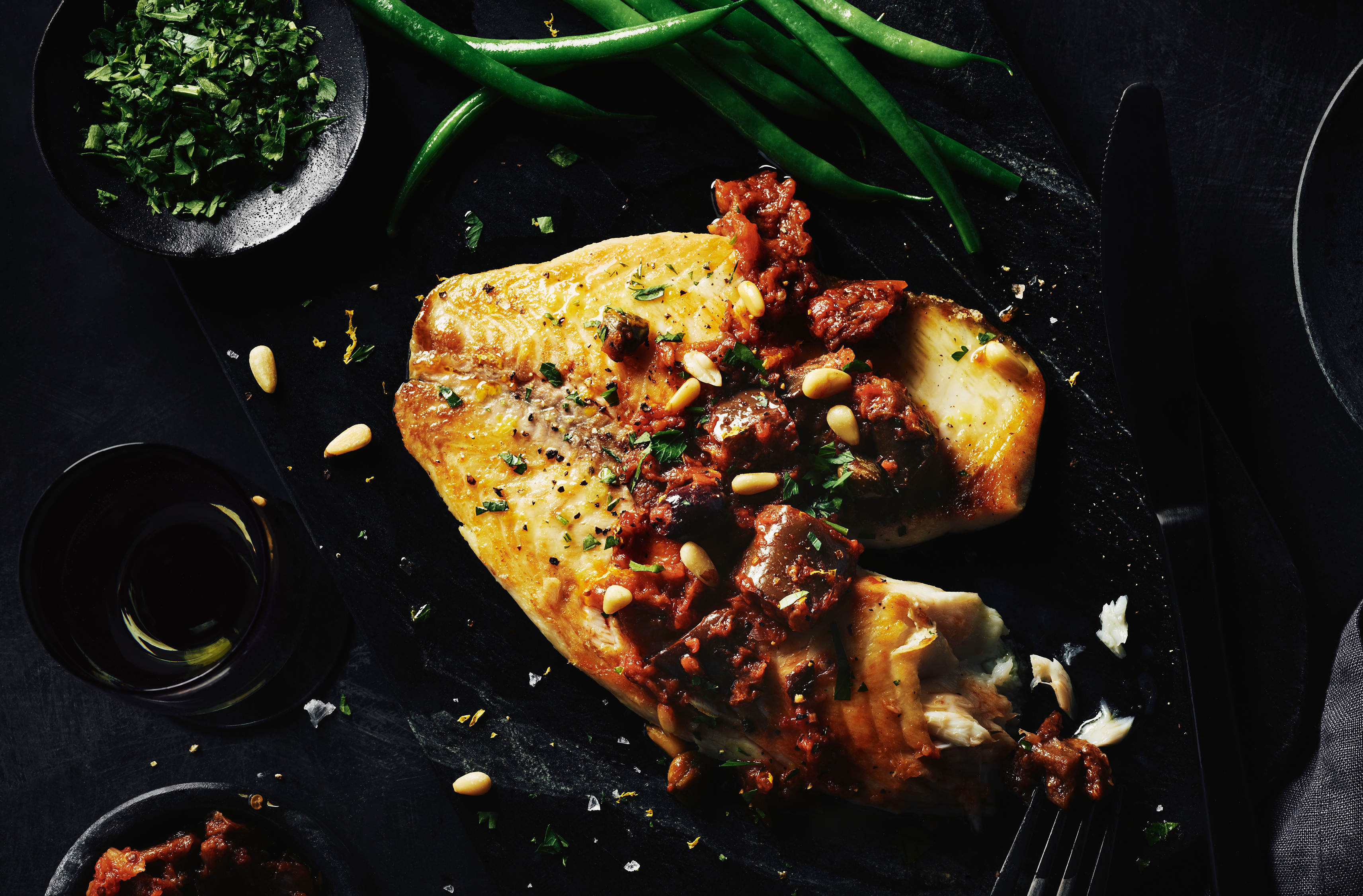 Lemon flavoured Tilapia topped with eggplant and olive caponata.  Some pine nuts sprinkled on top.