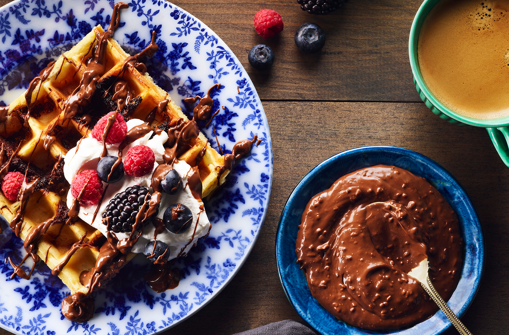 Waffle topped with chocolate hazelnut spread, whipped cream and fruit
