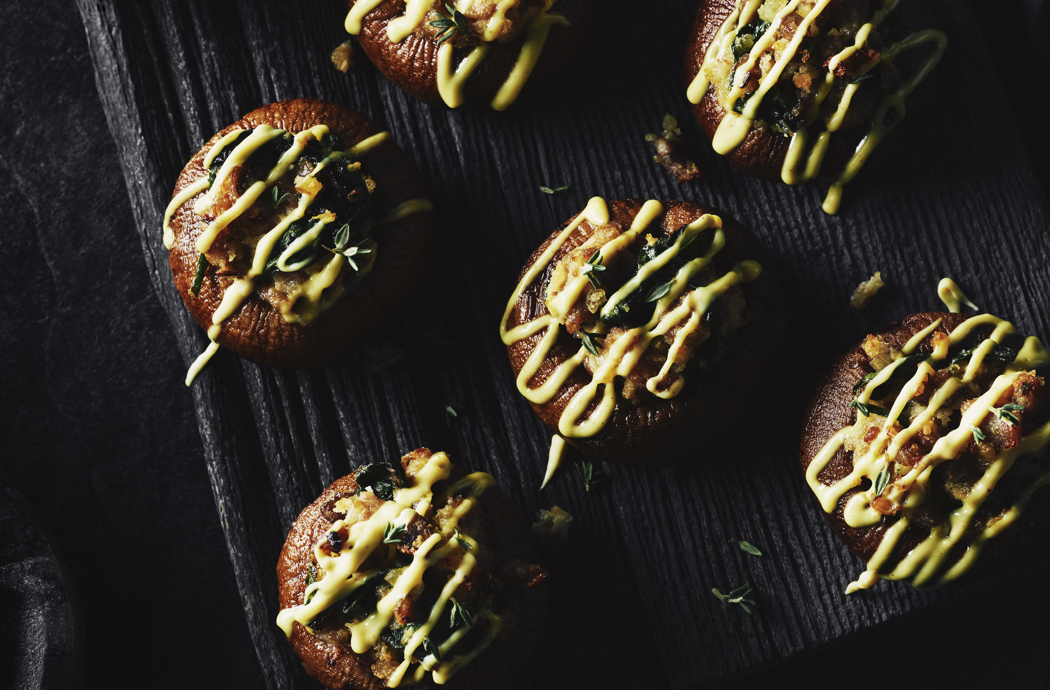 Sausage - stuffed mushroom caps drizzled with hollandaise sauce