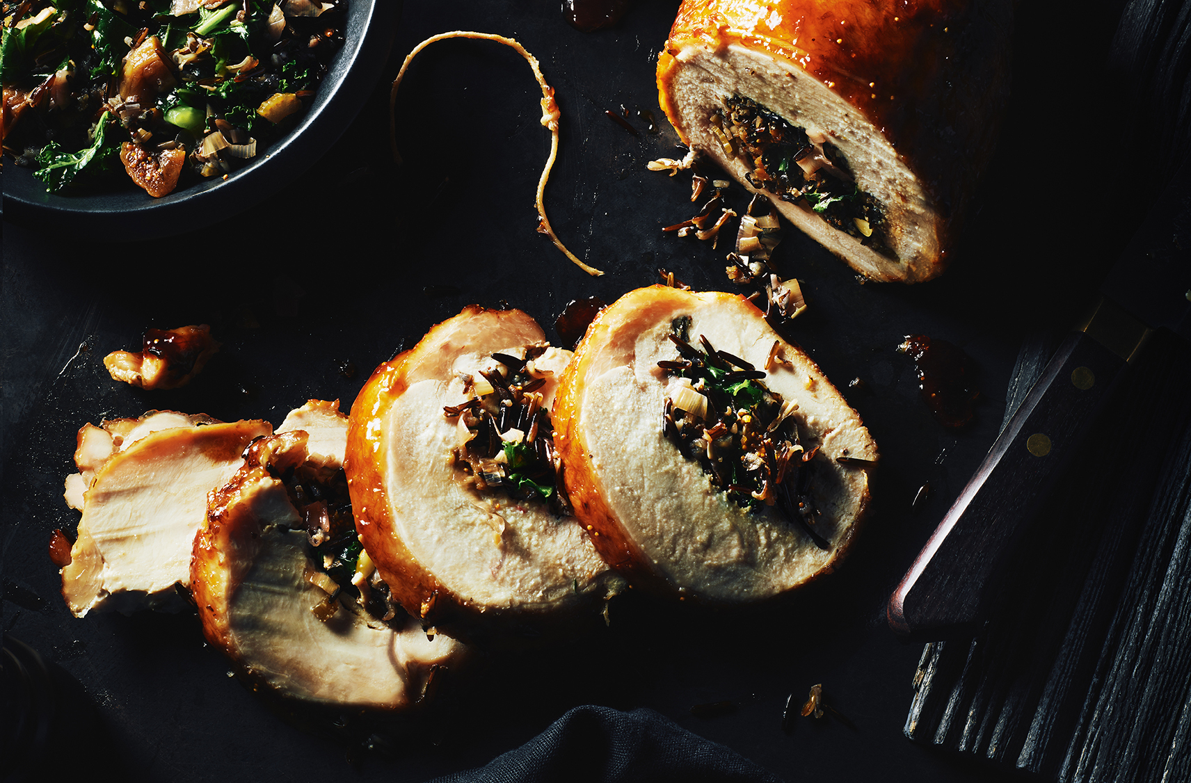 A partially sliced roast turkey with a fig cabernet stuffing in the center
