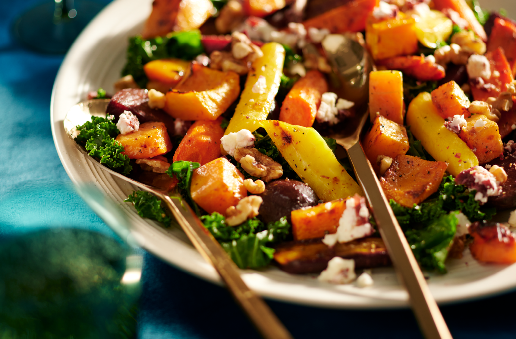 A close up image of a hearty cranberry salad with chucks of assorted root vegetables