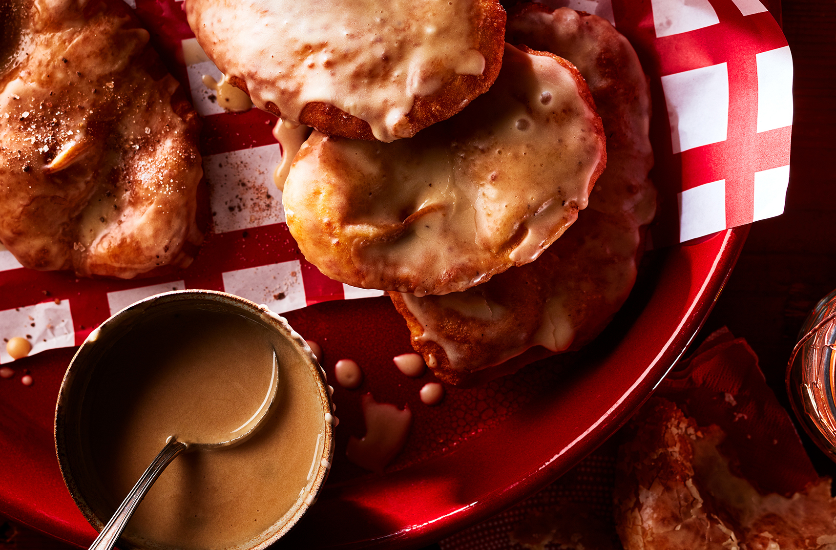 moose ear doughnuts with cold brew glazed served with a dipping sauce on the side.  All placed on a red plate