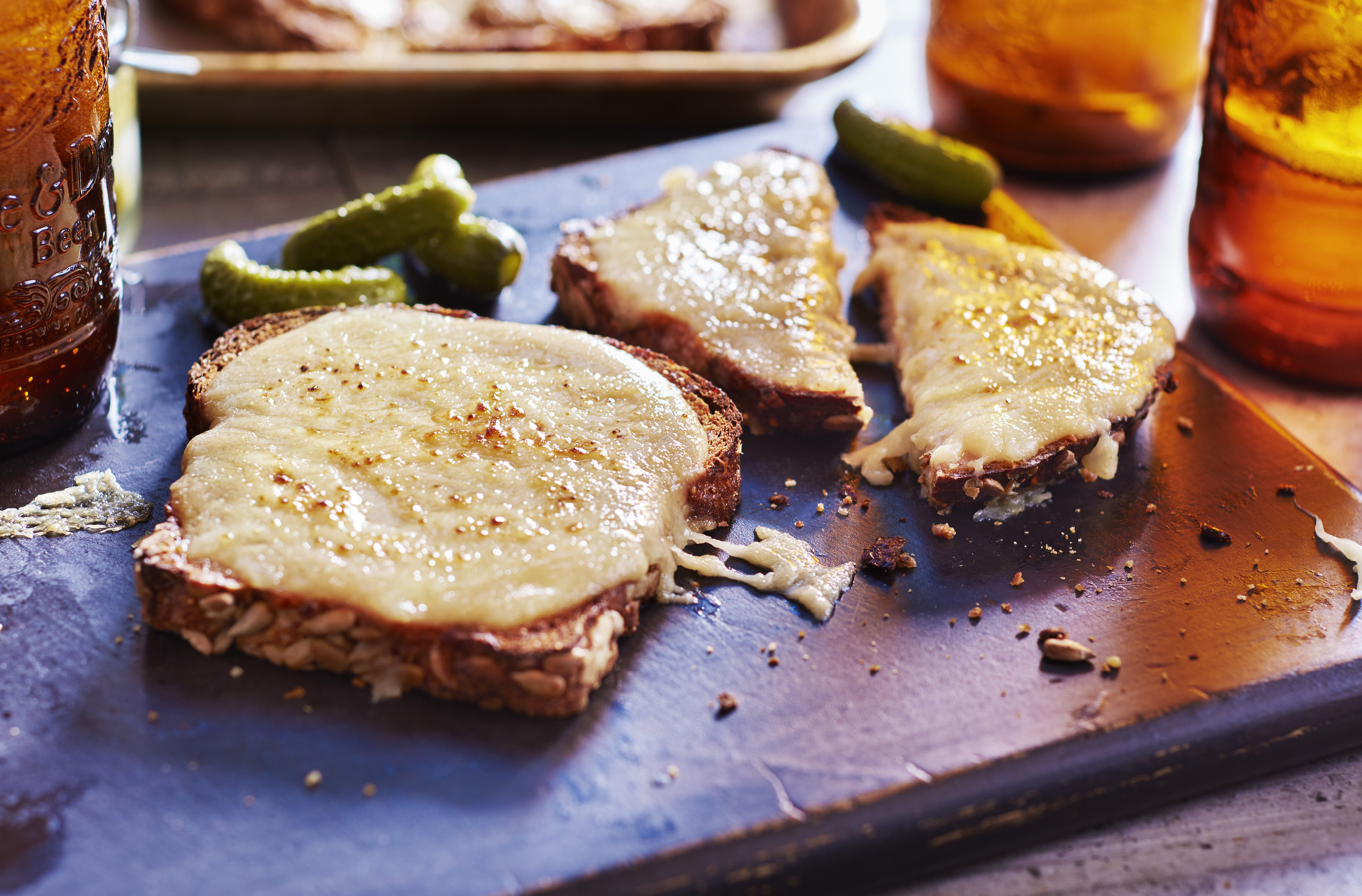 Slices of Welsh rarebit, comprised of toast covered in spiced cheese sauce
