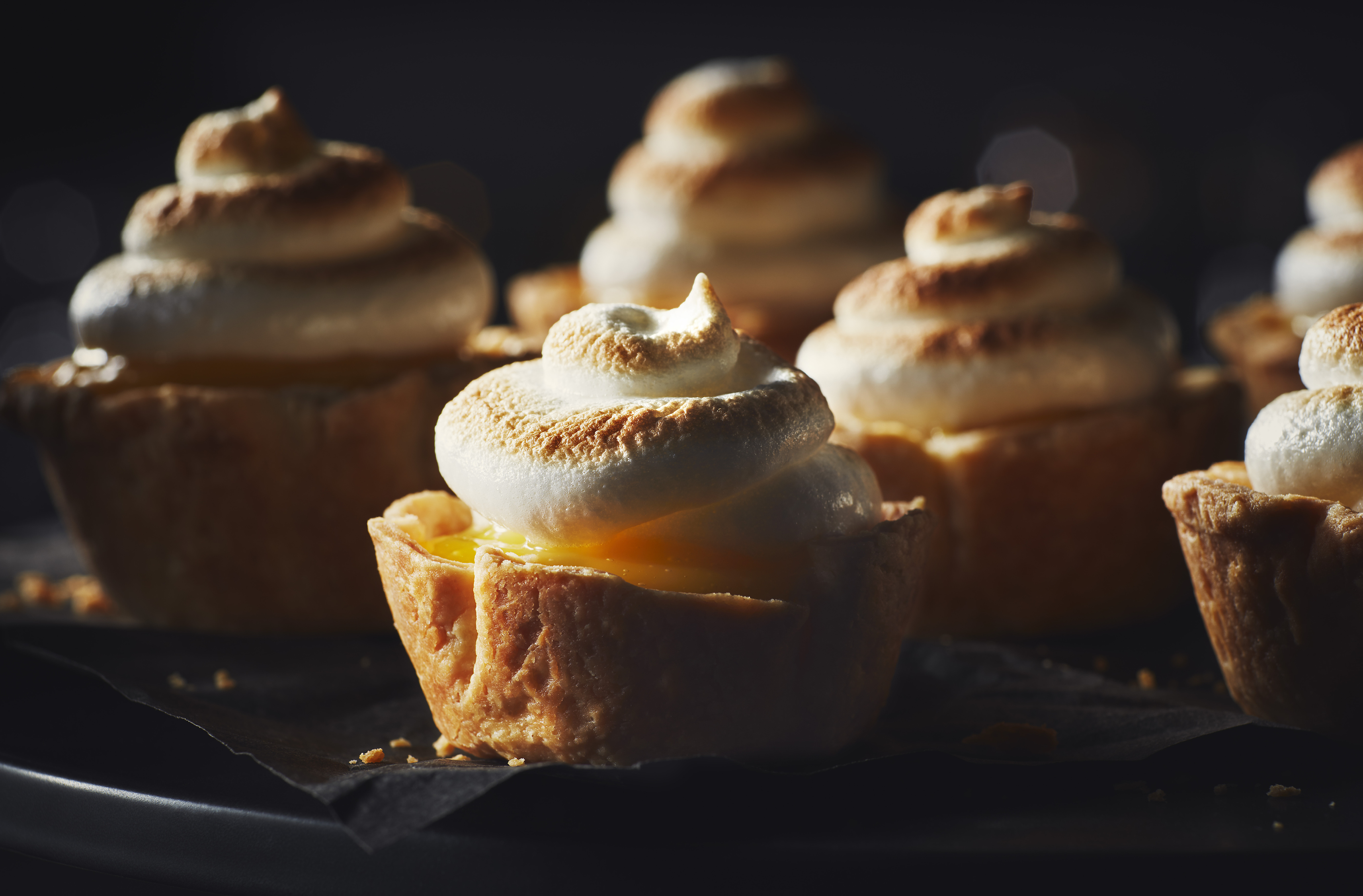 Four individual lemon meringue tarts
