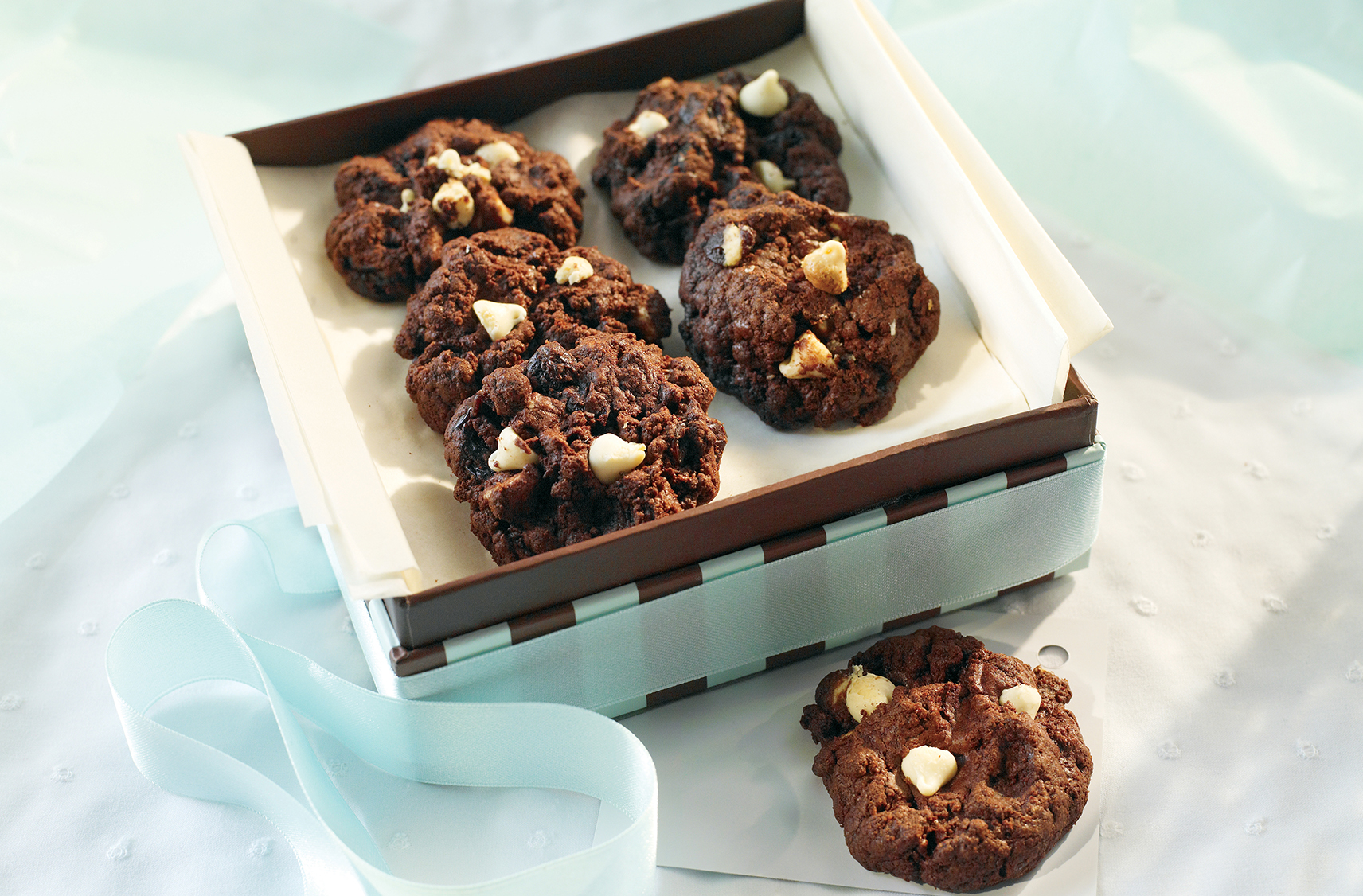 A box of Chocolate cherry brownie cookies with white chocolate chips