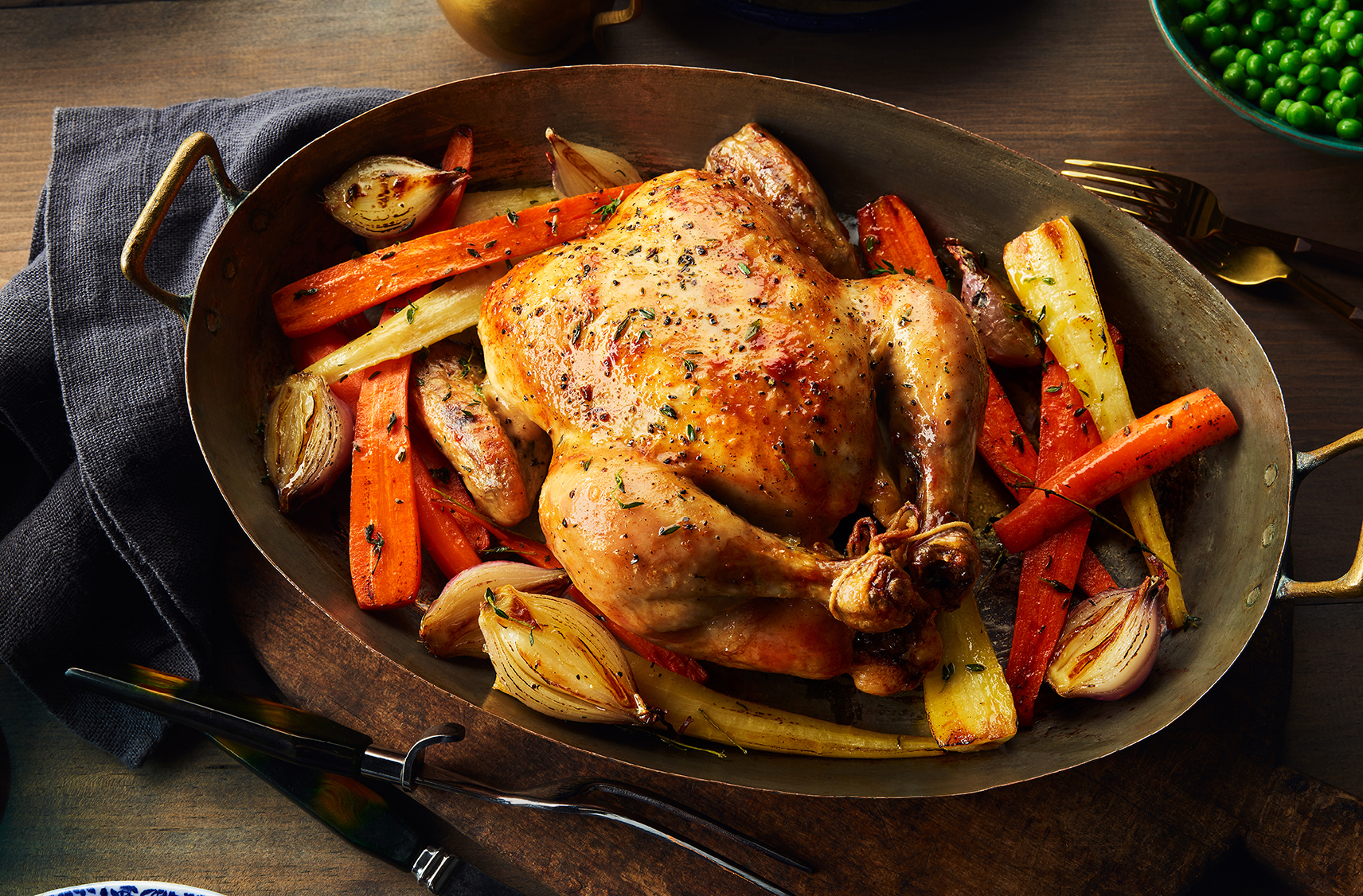Butter-infused roast chicken with carrots and parsnips on a platter