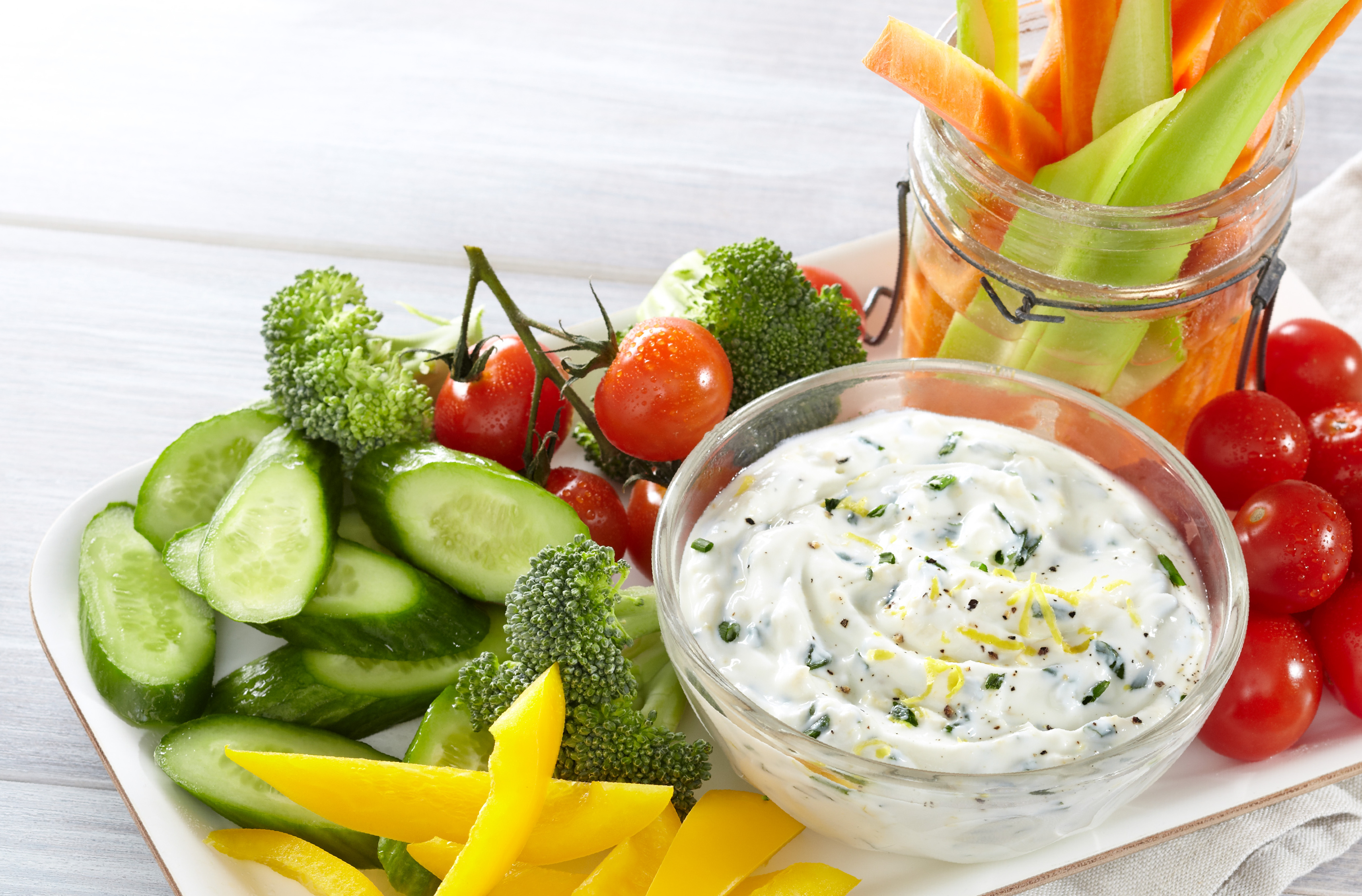 A large platter with vegetables and a bowl Lemon Chive Yogurt Dip