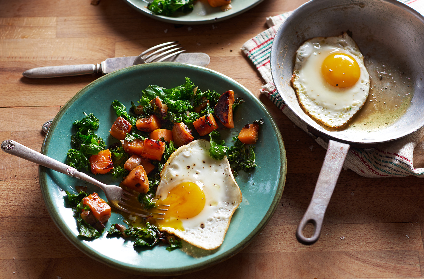 Caramelized sweet potato and wilted kale with a perfect sunny side up egg