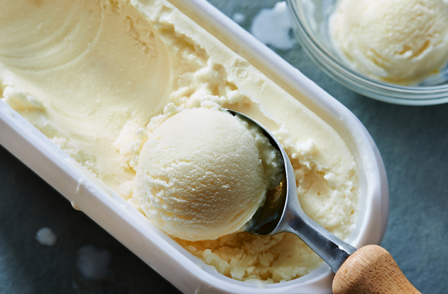 kefir lemon sorbet being scooped out of an ice cream container