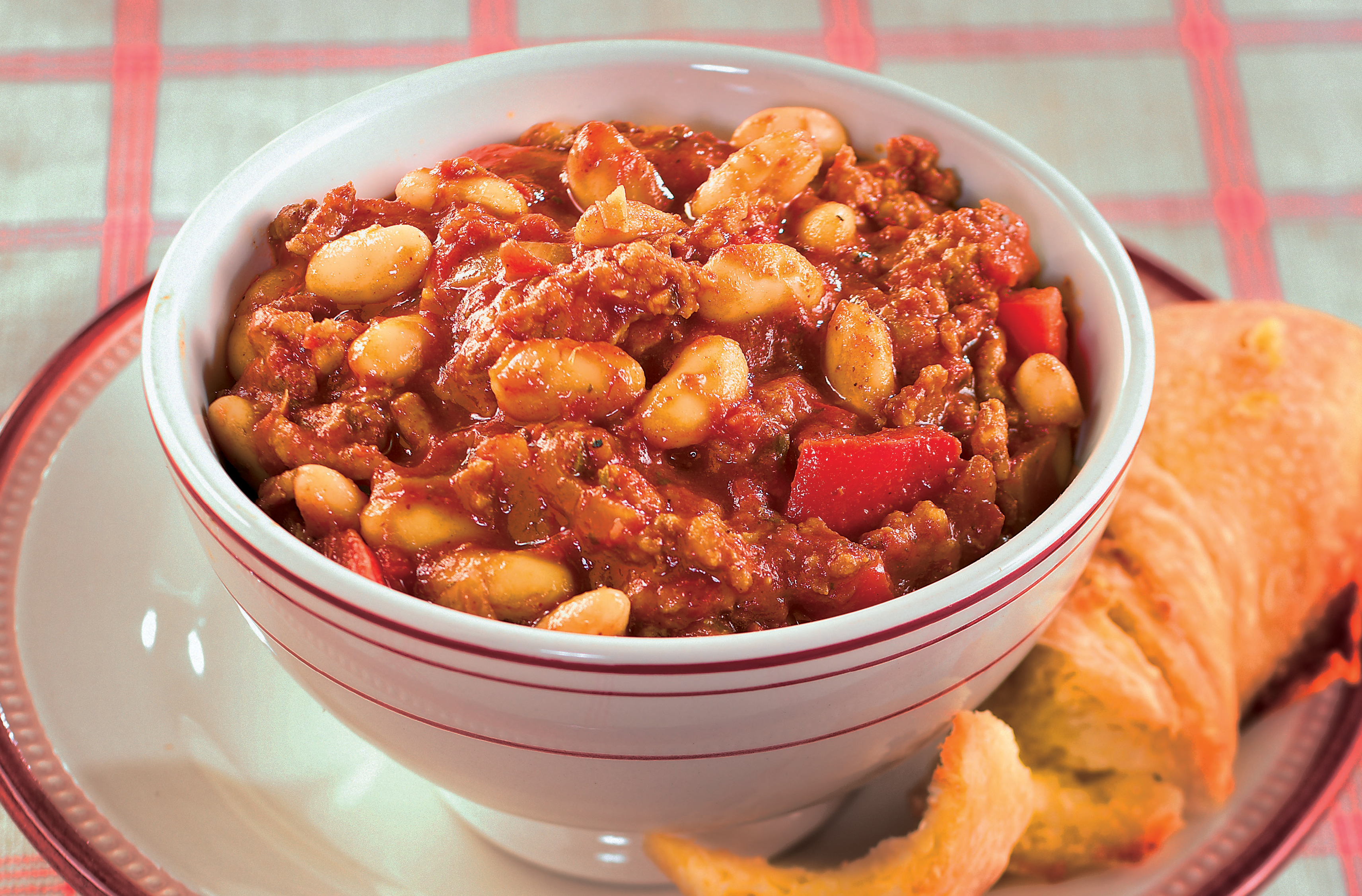 A bowl of turkey chili with white kidney beans & sweet red peppers
