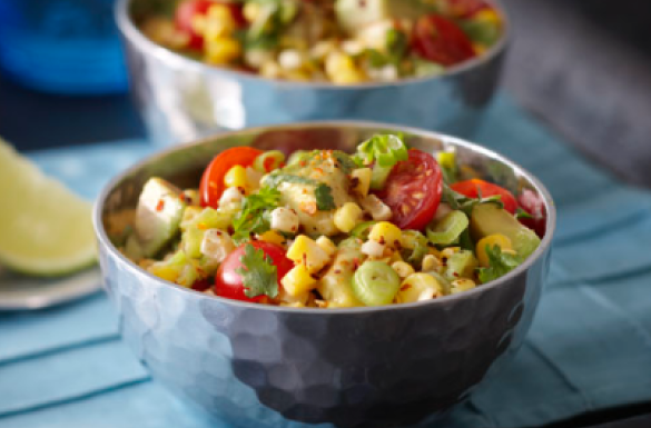 2 bowls of harissa grilled corn salad with corn, tomatoes, onions & avocado
