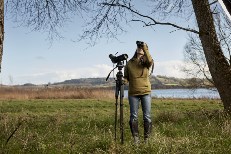 Mya-Rose using spotting scope and binoculars