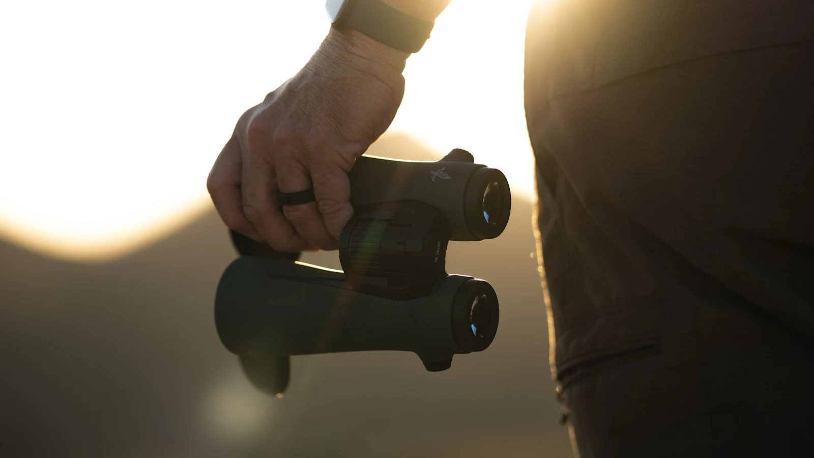 Observer carrying the Swarovski NL Pure 52 in warm backlight at the end of the day