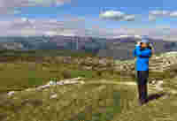 My birding patch: Gigi Sahlstrand looking through binoculars in bosnia herzegovina