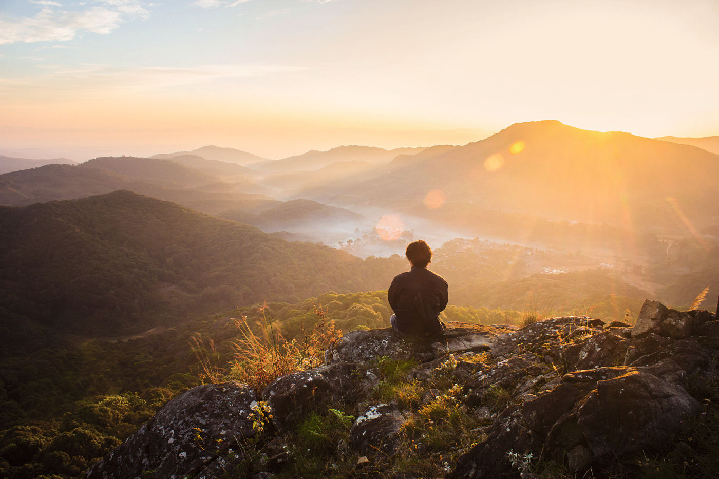 Alone man watch over valley to Sun. 