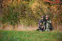 SLC, two hunters sitting on the ground in camo outfit