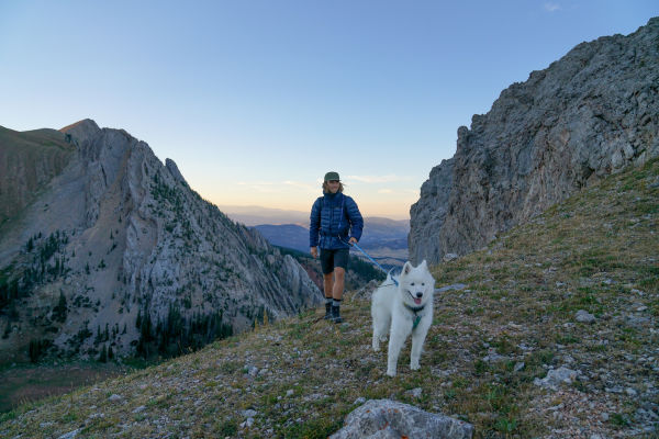 Charles Post walking with his dog up in the mountains 