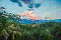 Sunset over the rolling lush green hills of the Antioquia landscape near Santa Fe, just outside the city of Medellin, Colombia