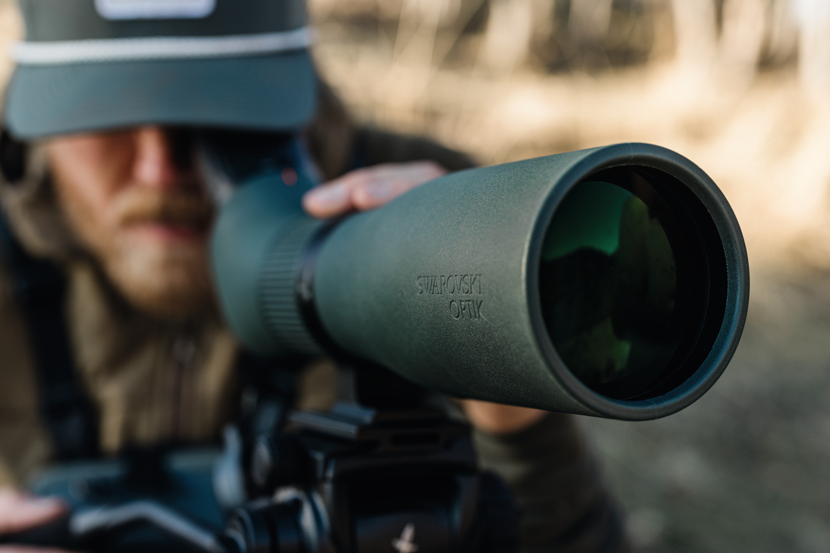 Observer carrying the Swarovski AT Endura spotting scope through open terrain