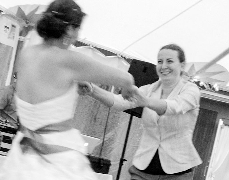 Black and white photo of the brides dancing together near the DJ booth at their wedding reception in Shelburne, Vermont